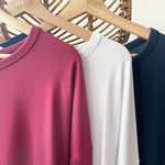 Close up of three bamboo t-shirts in red, white and blue made in canada