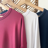 Close up of three bamboo t-shirts in red, white and blue made in canada