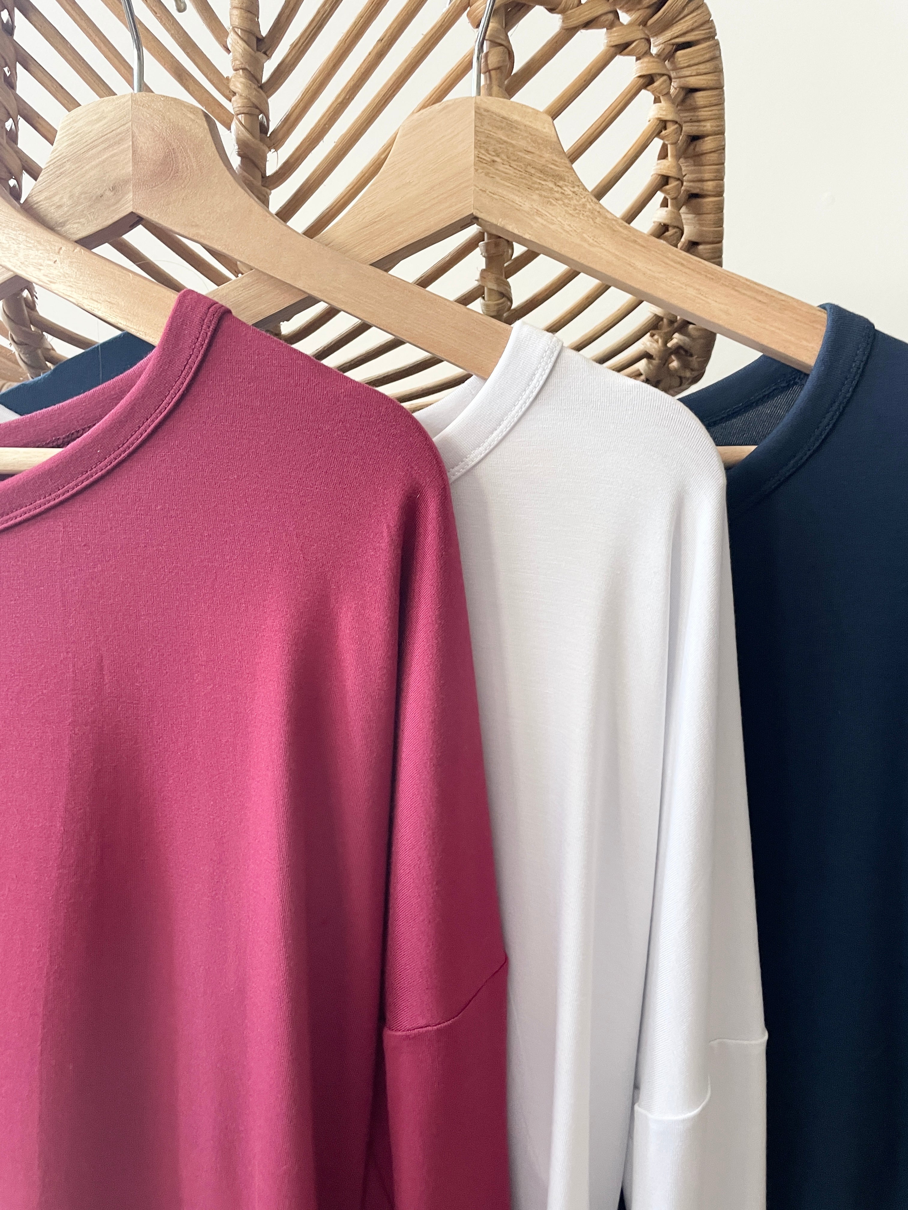 Close up of three bamboo t-shirts in red, white and blue made in canada