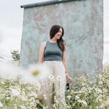 woman wearing teal tank top with linen pants