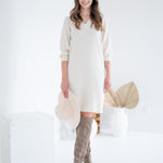 front view of woman wearing cream sweater dress