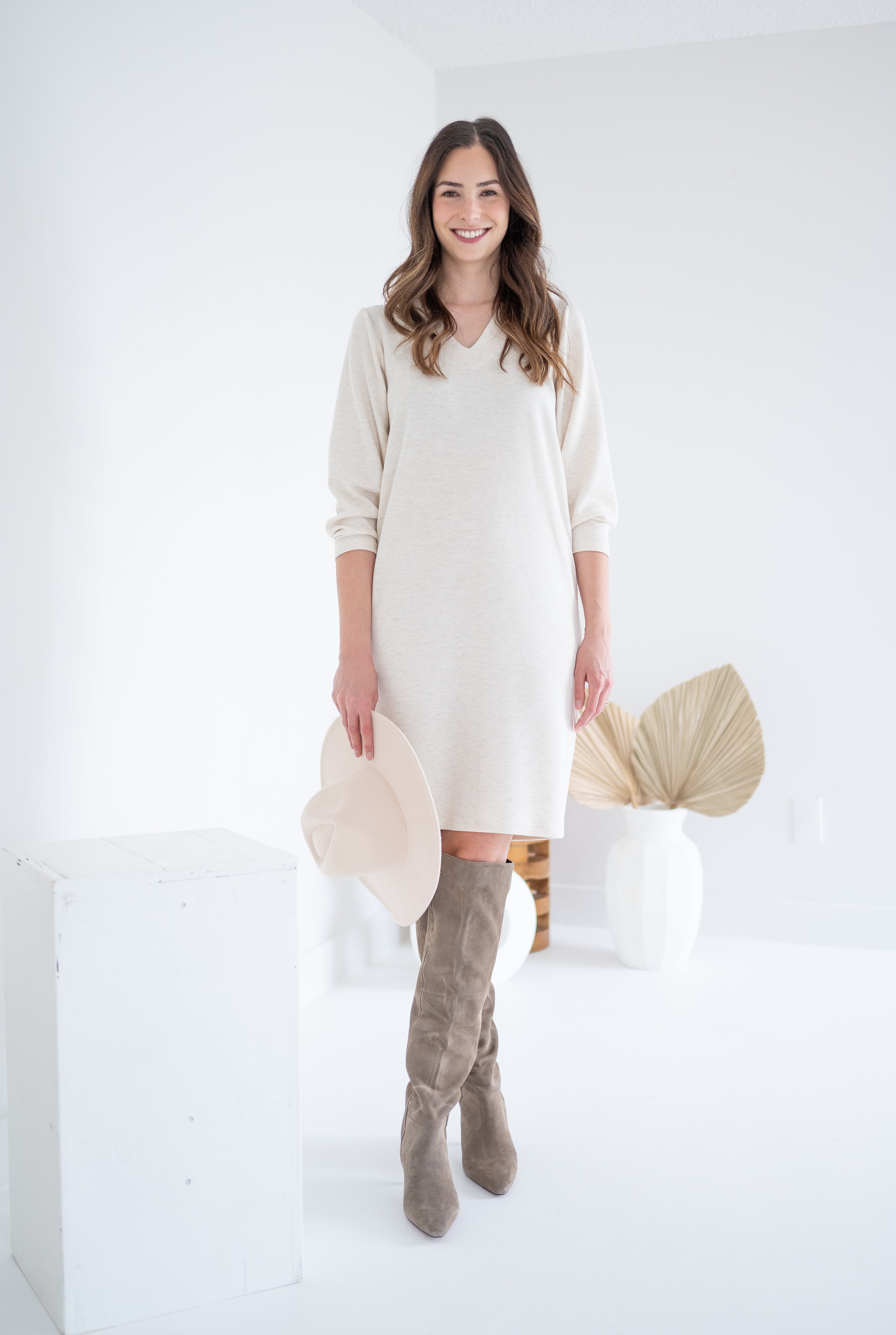 front view of woman wearing cream sweater dress