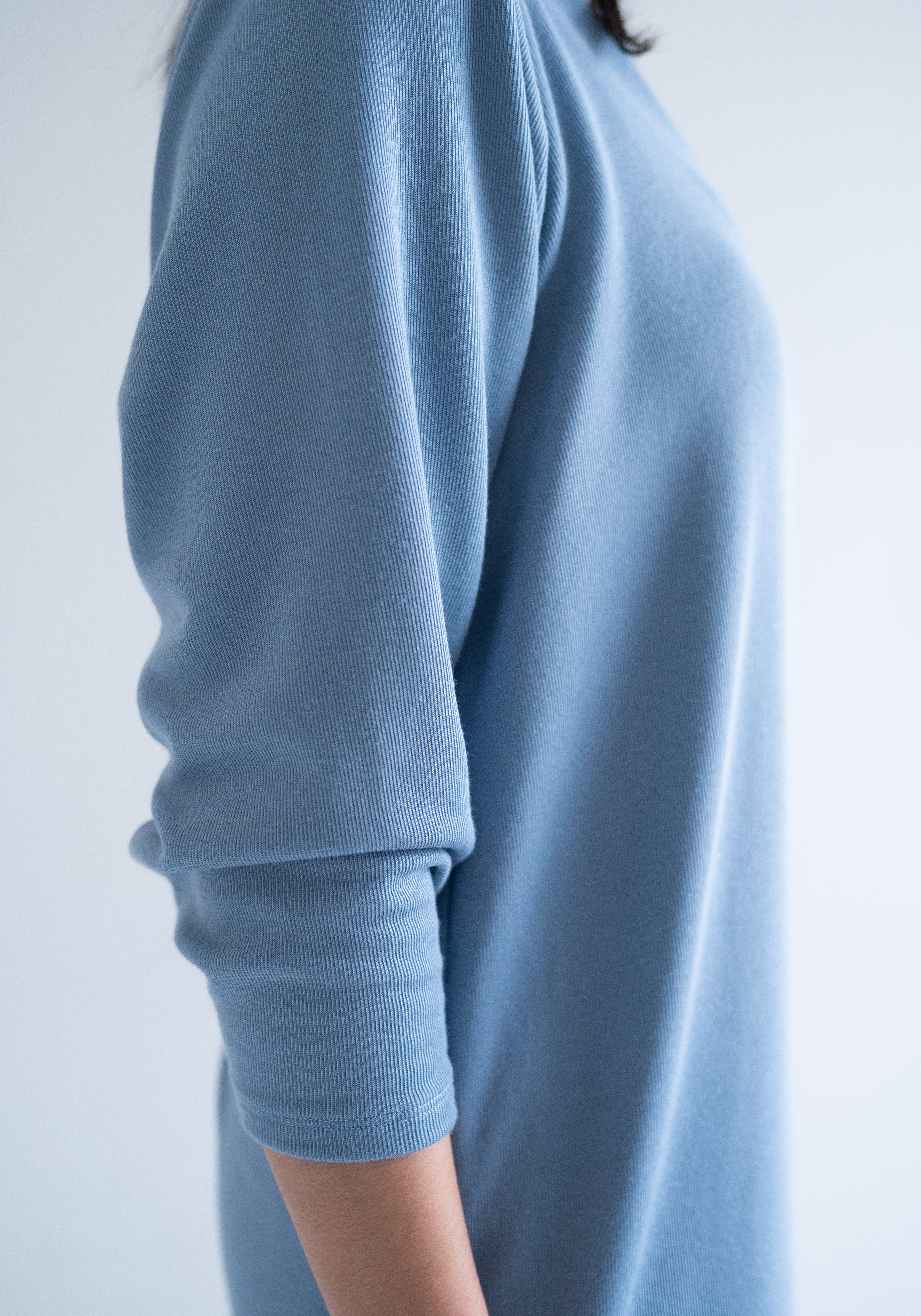 close up of blue long sleeved dress in sky blue