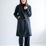 front view Black wool coat with one button. Wide collar knee length. Made in canada.