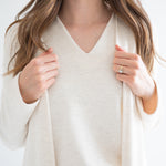 close up of Ang Hill women's cream v-neck sweater paired with long cream cardigan for women