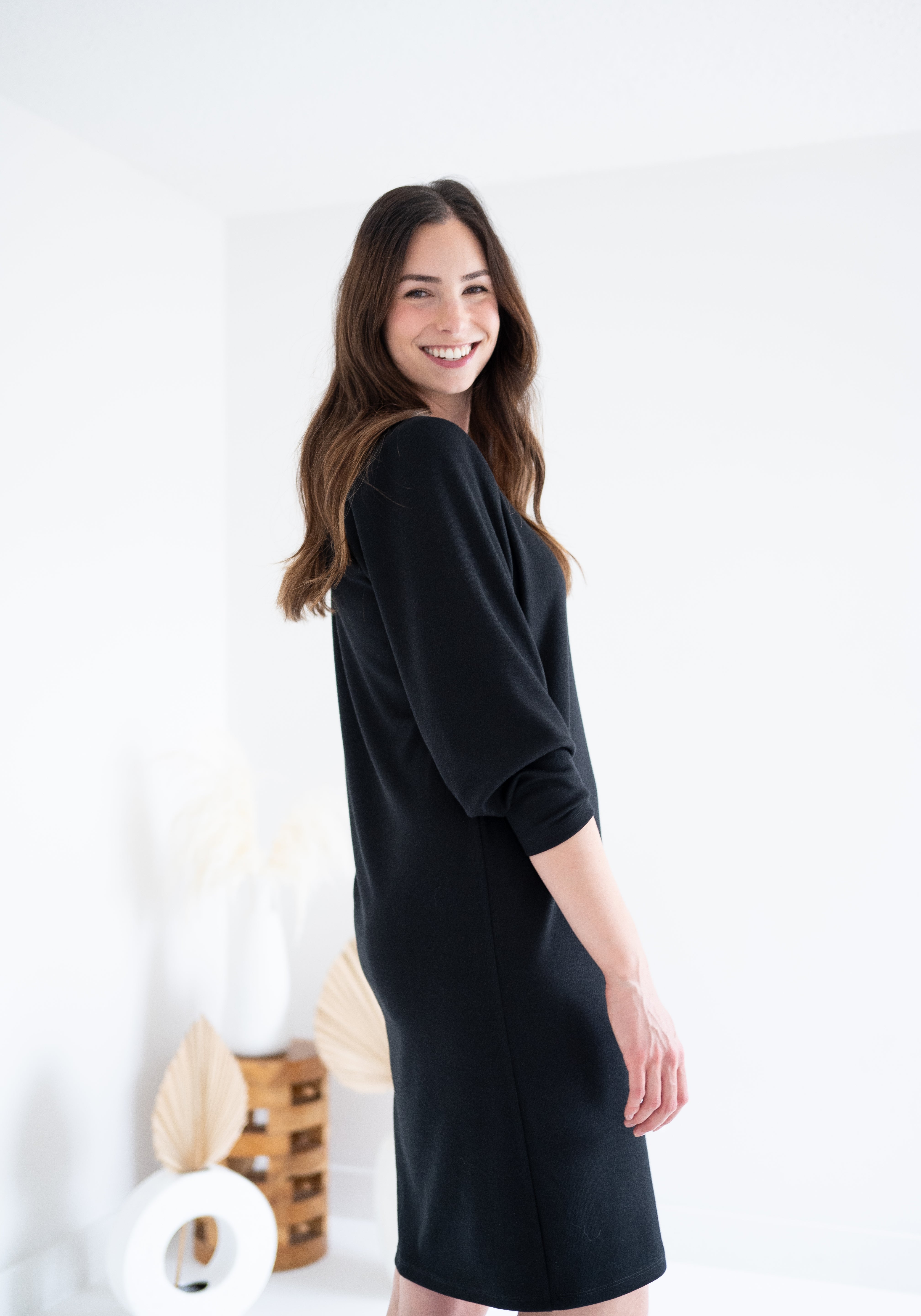 side view of black knee length sweater knit dress for women