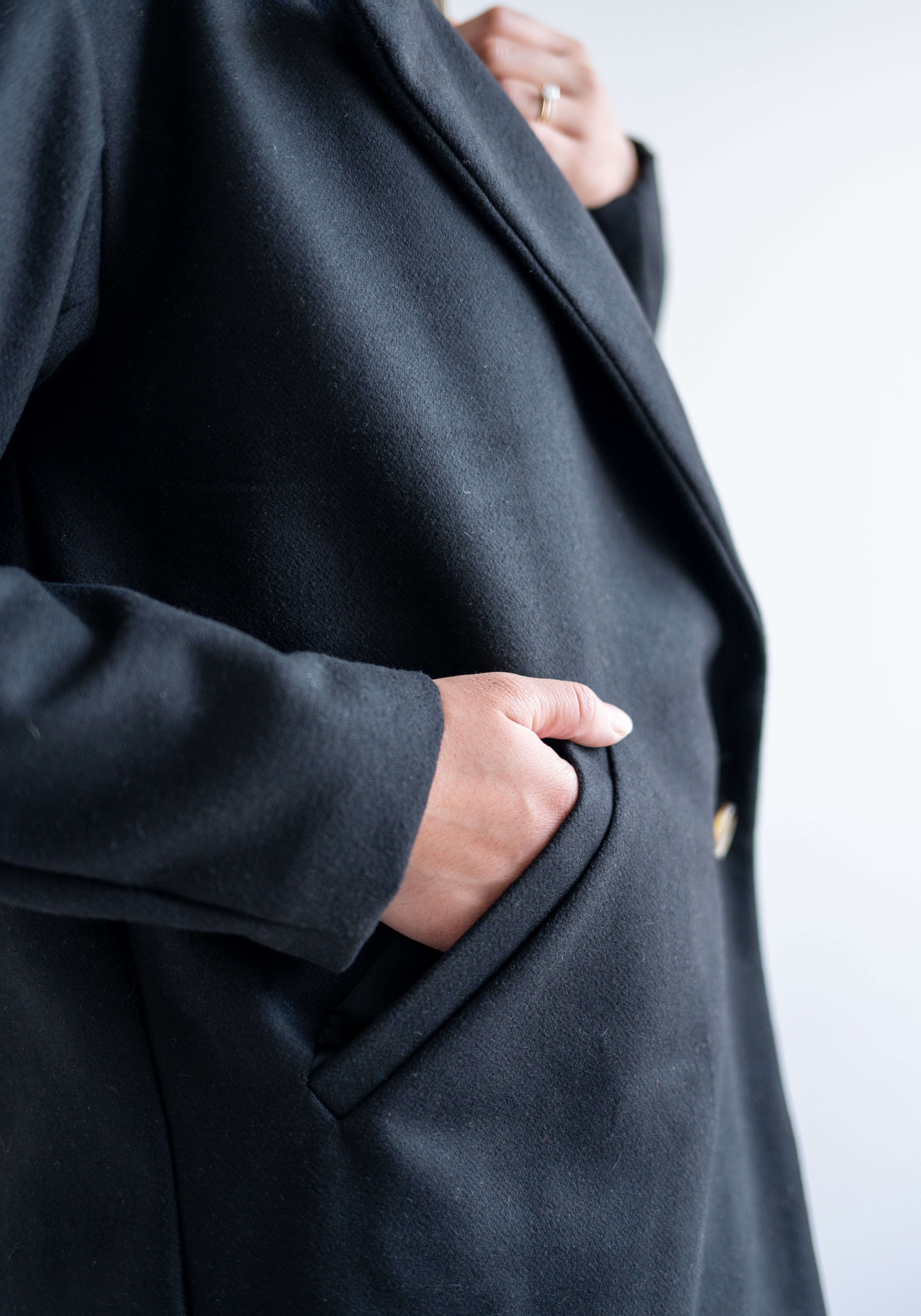 close up of black wool coat pocket