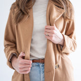 mockneck cream sweater with camel wool coat