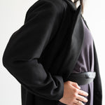 size view of black wool blend coat with grey long sleeved dress