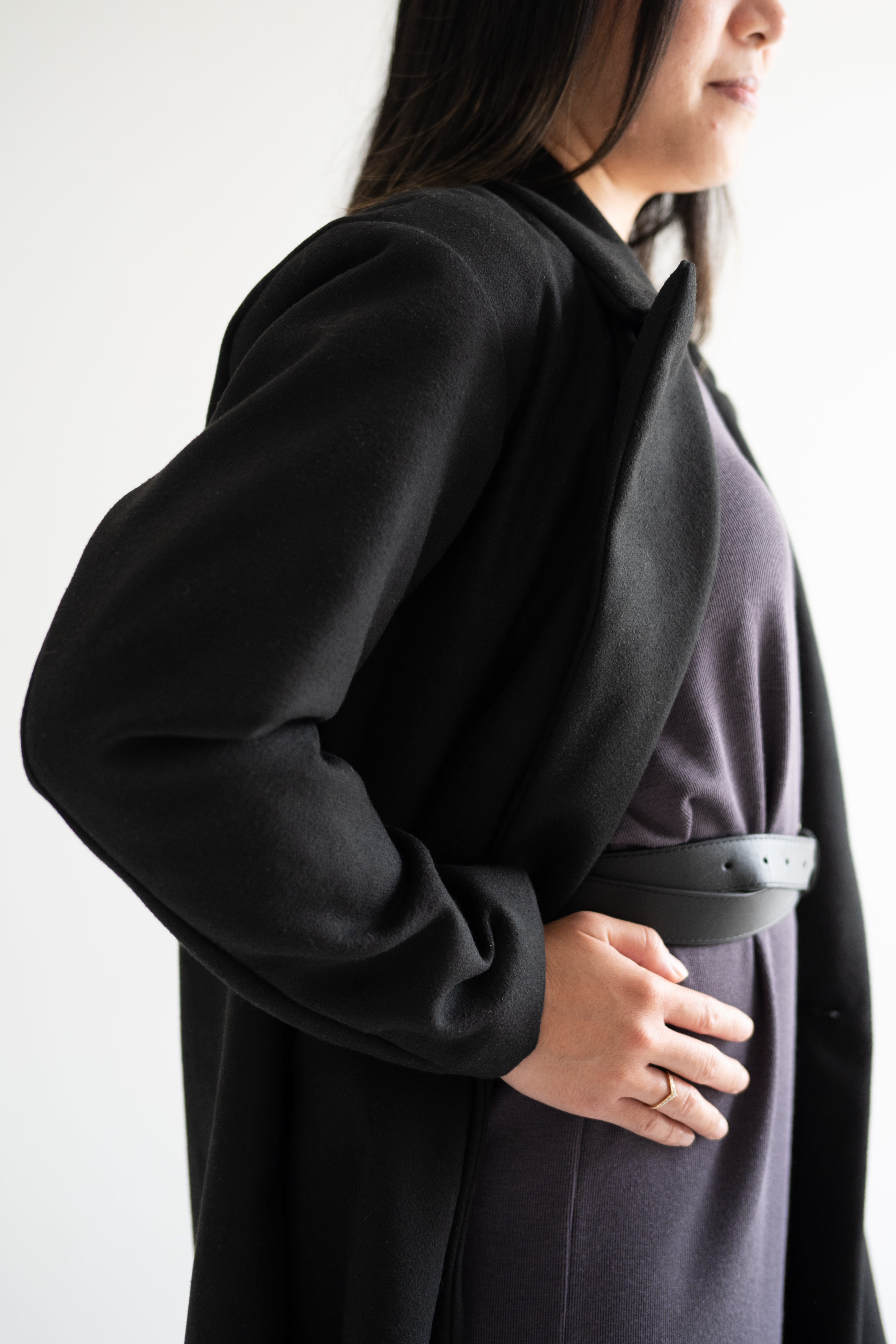 size view of black wool blend coat with grey long sleeved dress