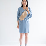 Sky Blue sweater dress with long sleeves for women with fanny pack and sneakers