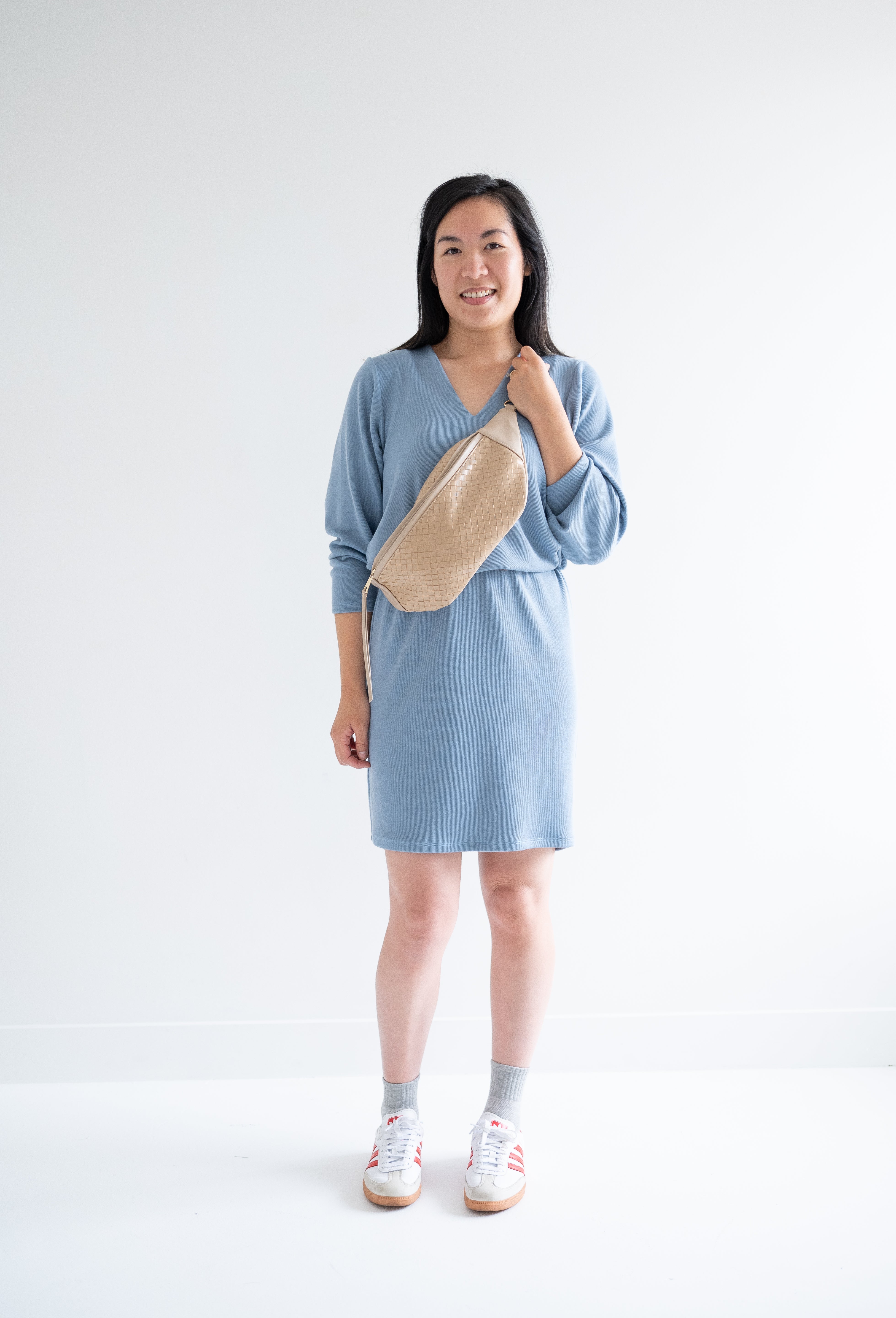 Sky Blue sweater dress with long sleeves for women with fanny pack and sneakers