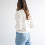 back view of cream cropped sweater for women