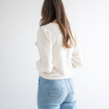 back view of cream cropped sweater for women