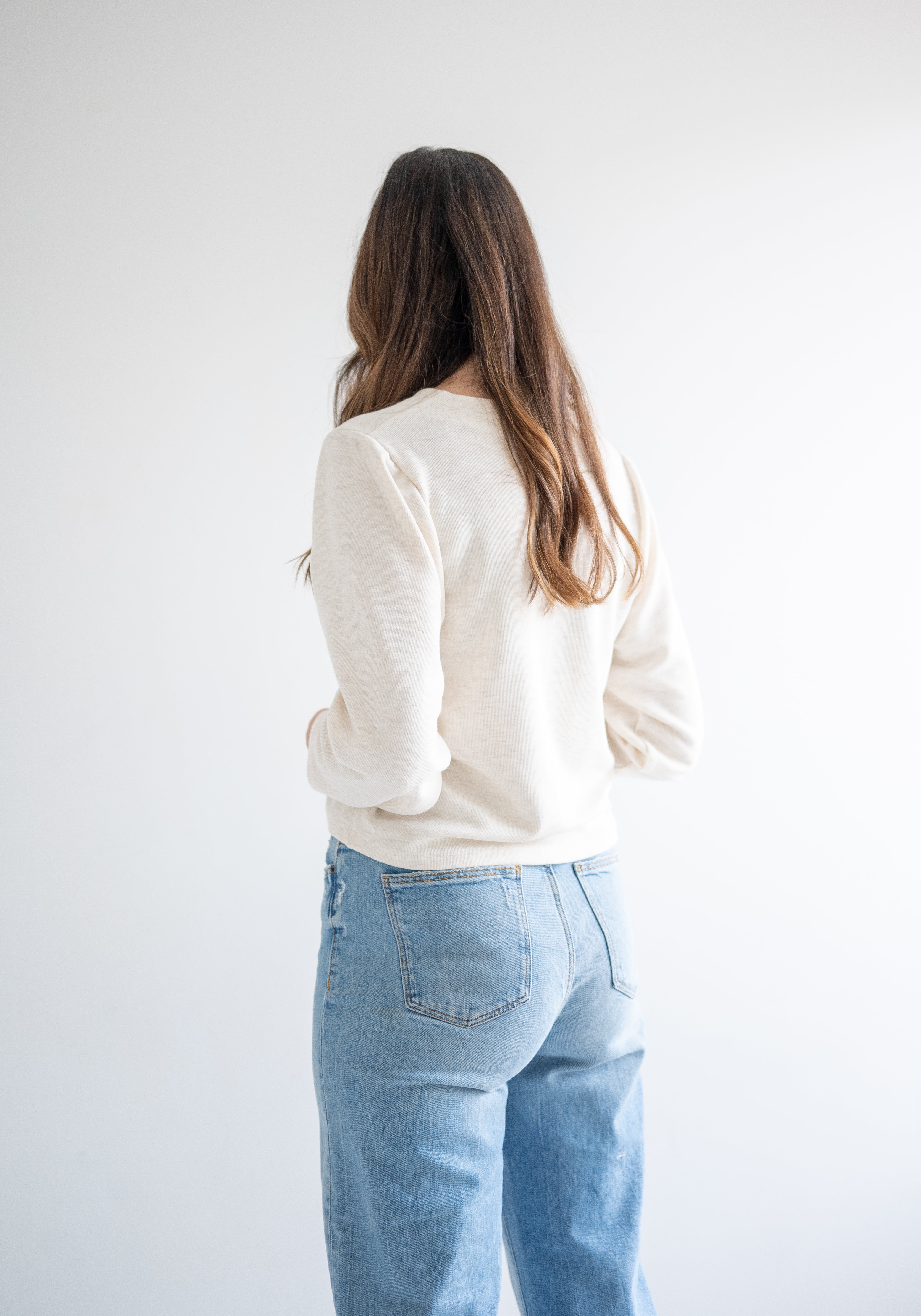 back view of cream cropped sweater for women