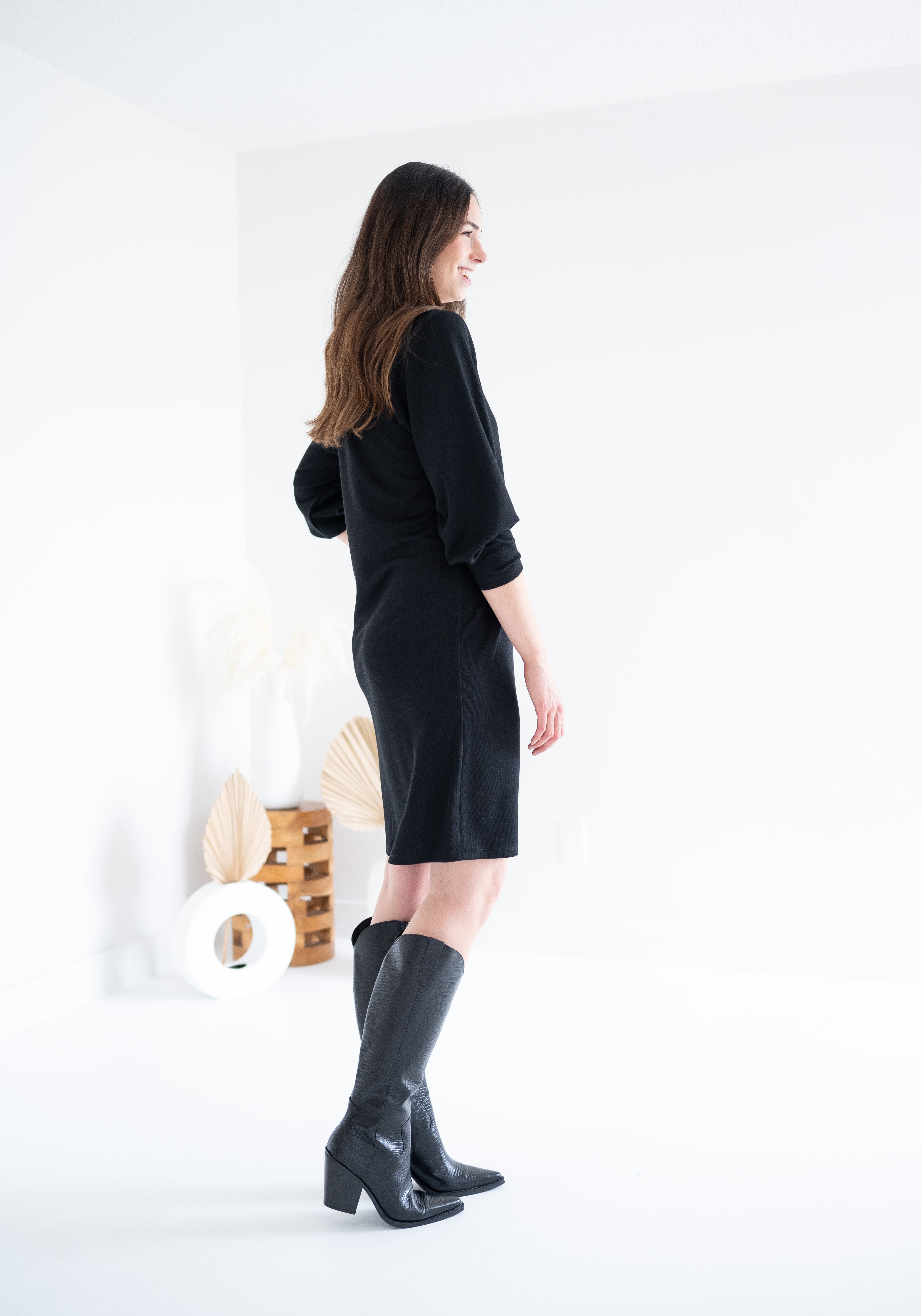 back view of black knee length sweater knit dress for women