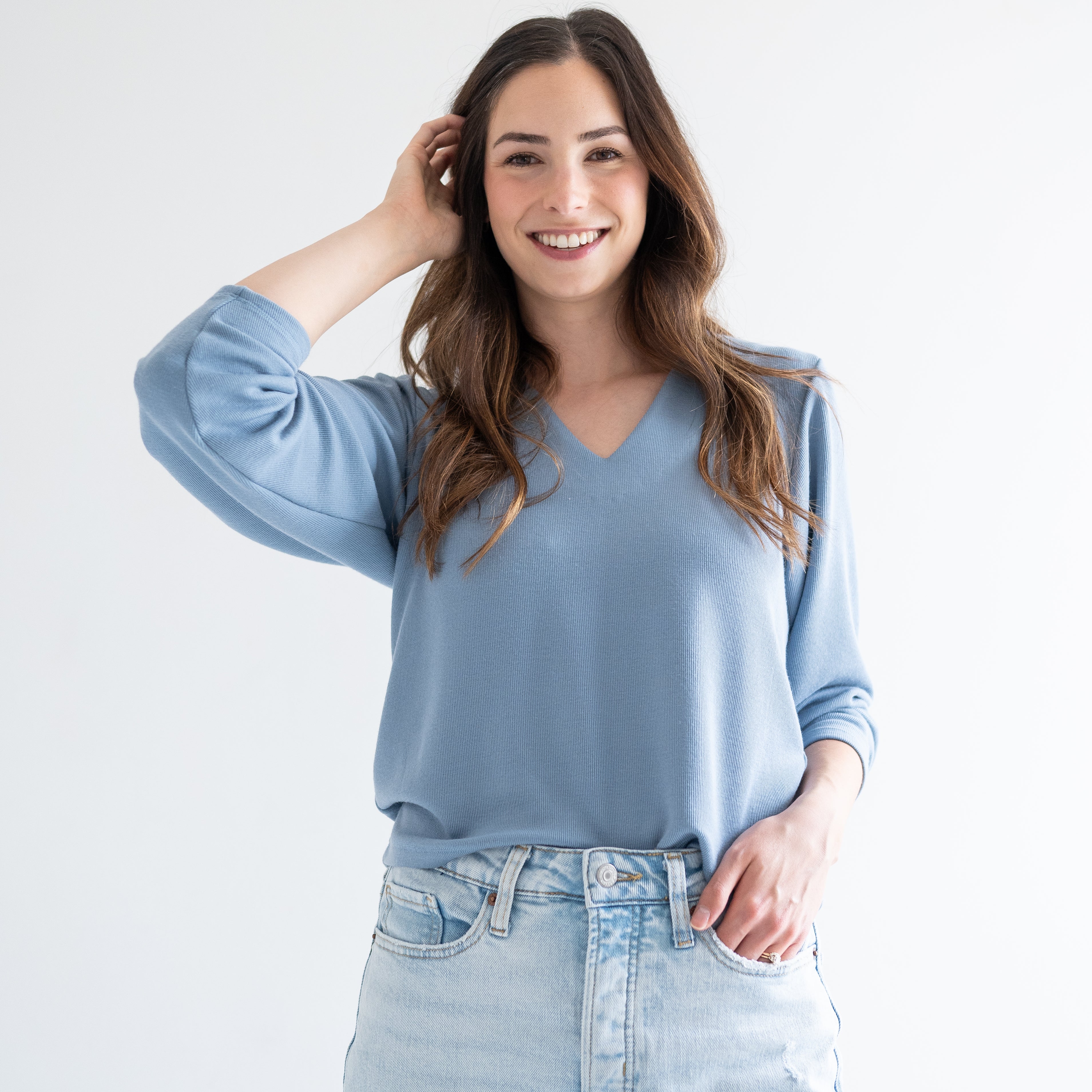 front view woman wearing blue v-neck sweater