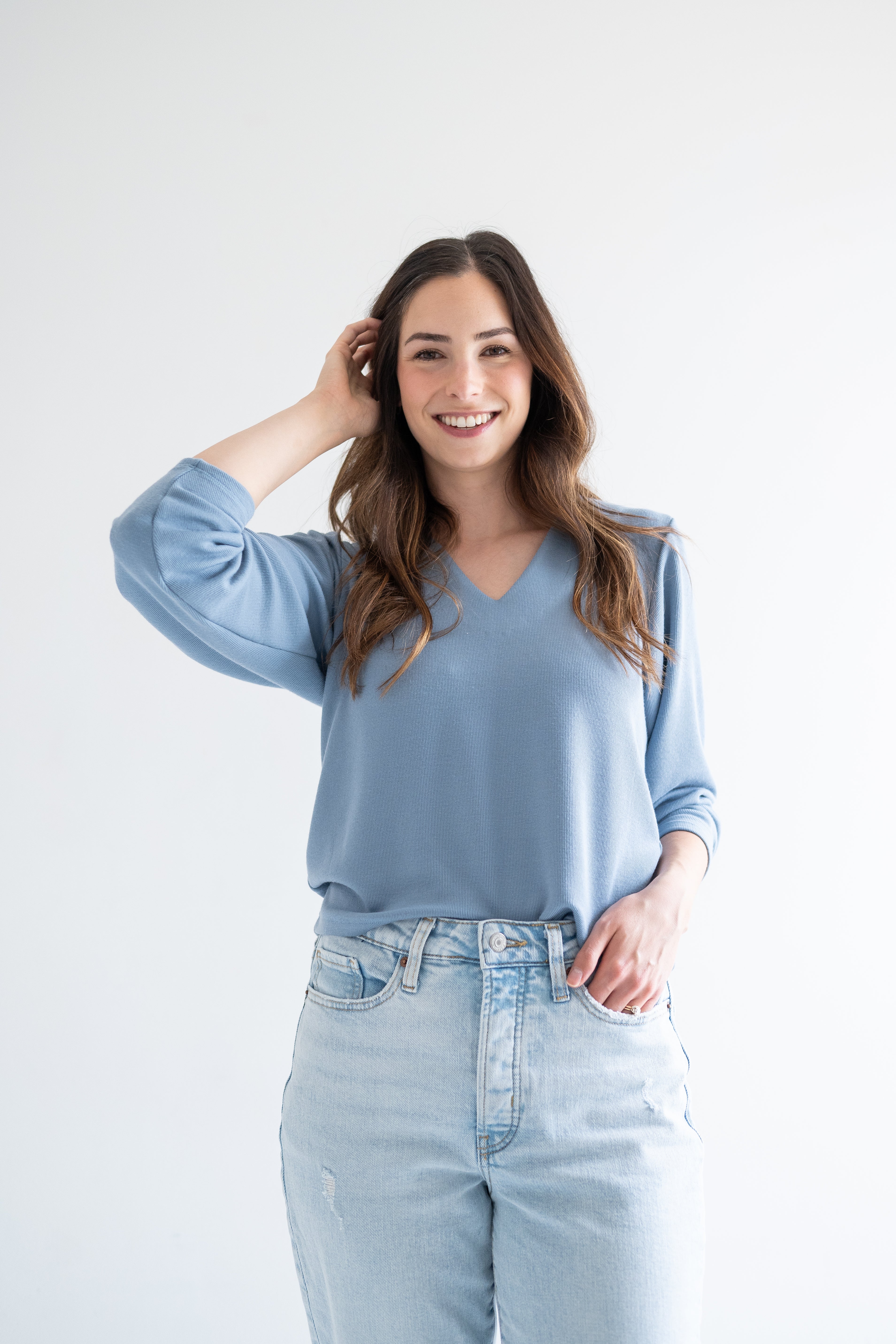 front view woman wearing blue v-neck sweater