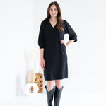 front view of black vneck long sleeved sweater knit dress for women