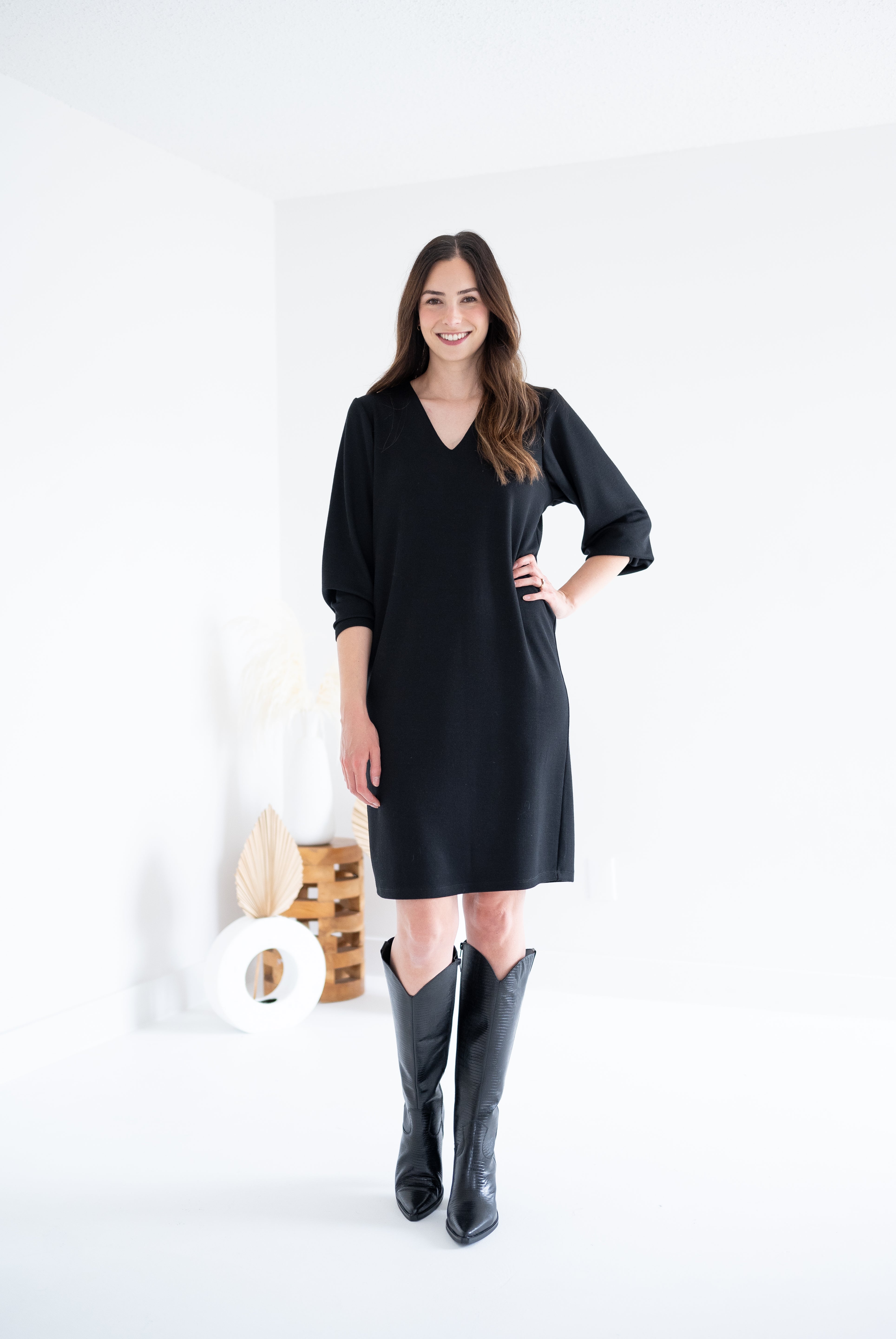 front view of black vneck long sleeved sweater knit dress for women