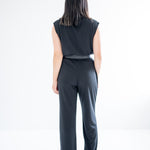 back view of sretchy wide leg pants for women and black mockneck sweater