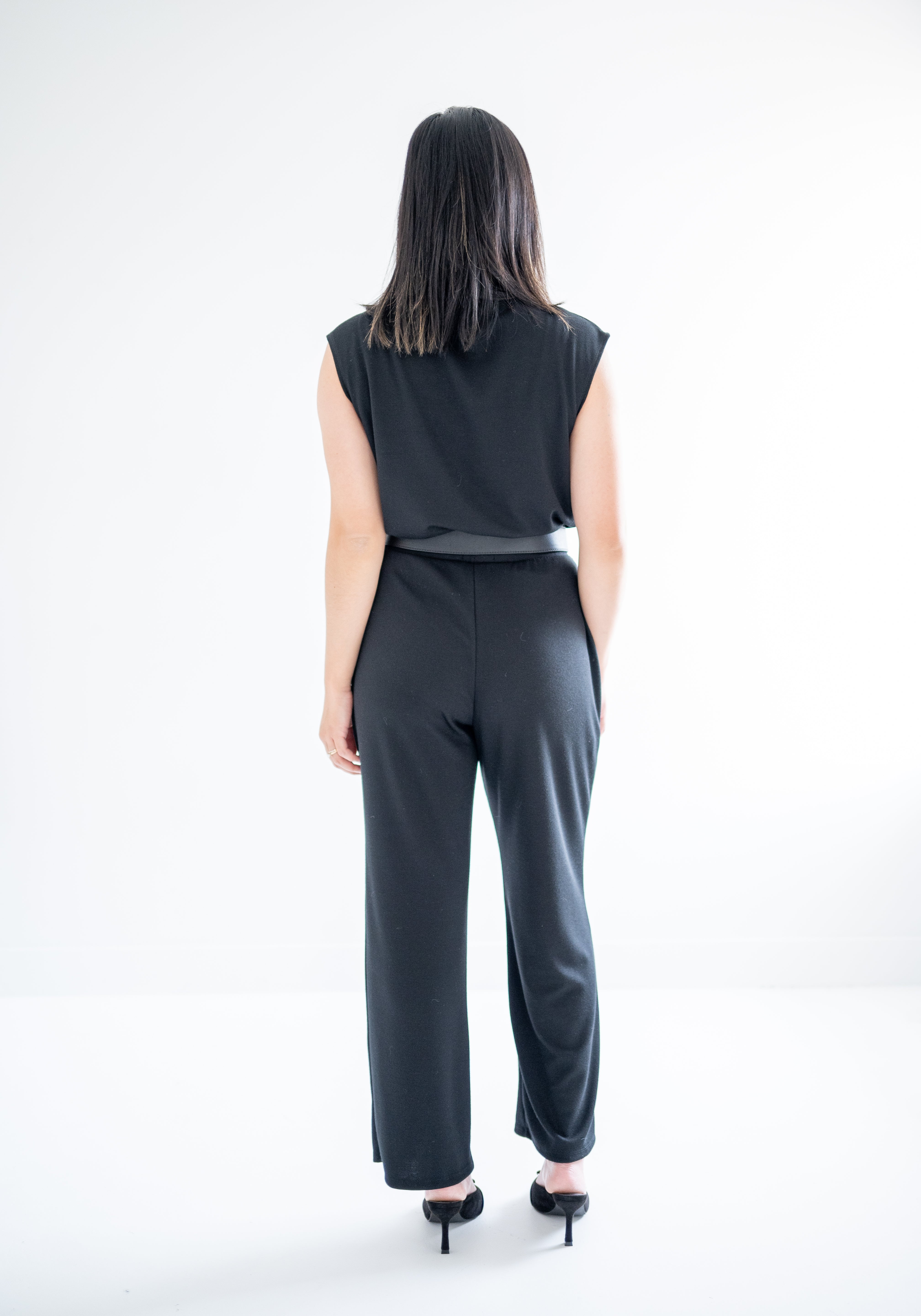 back view of sretchy wide leg pants for women and black mockneck sweater