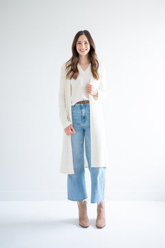 Woman wearing long cream cardigan