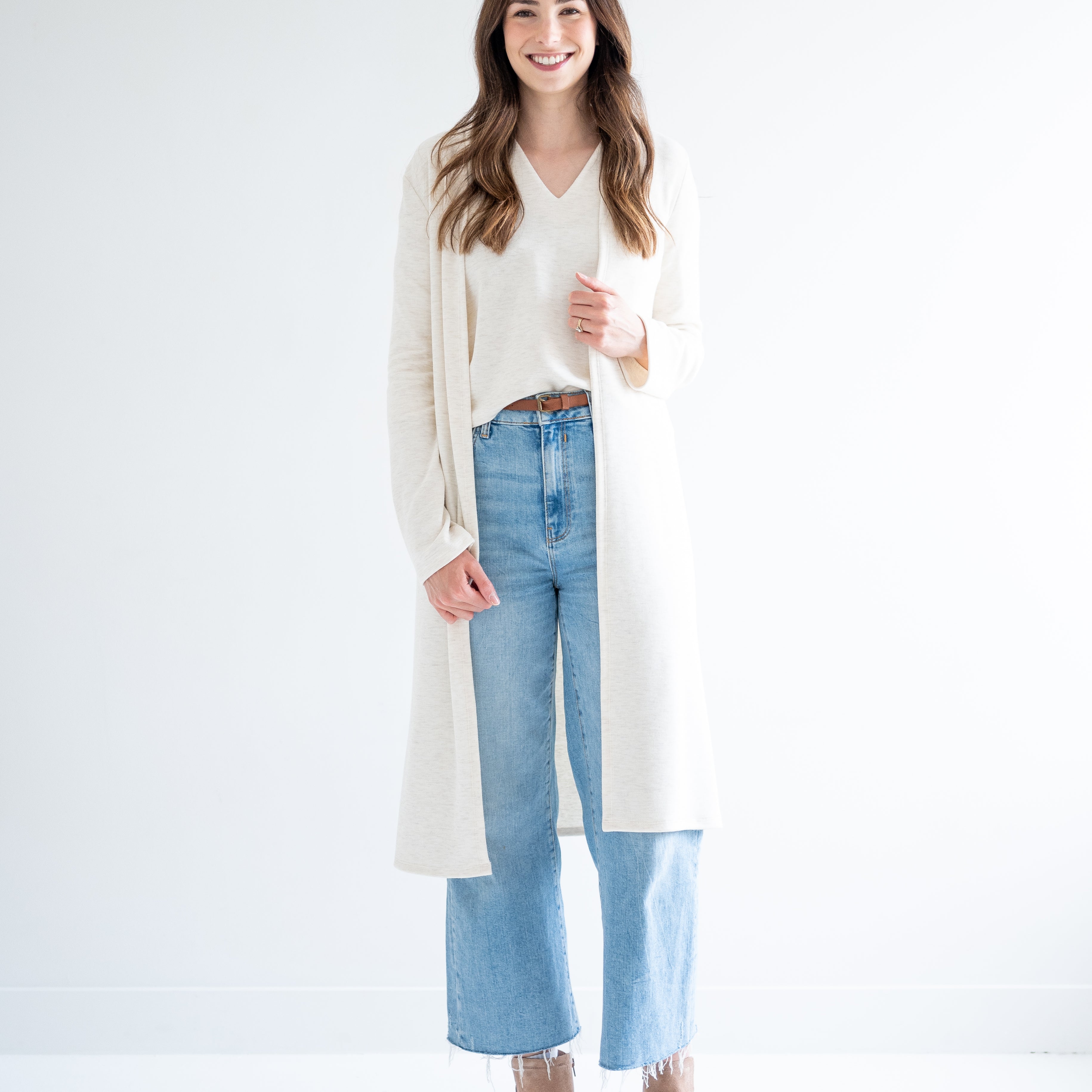 Woman wearing long cream cardigan