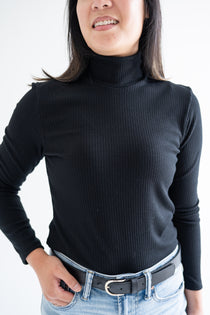 Close up of black turtleneck top for women