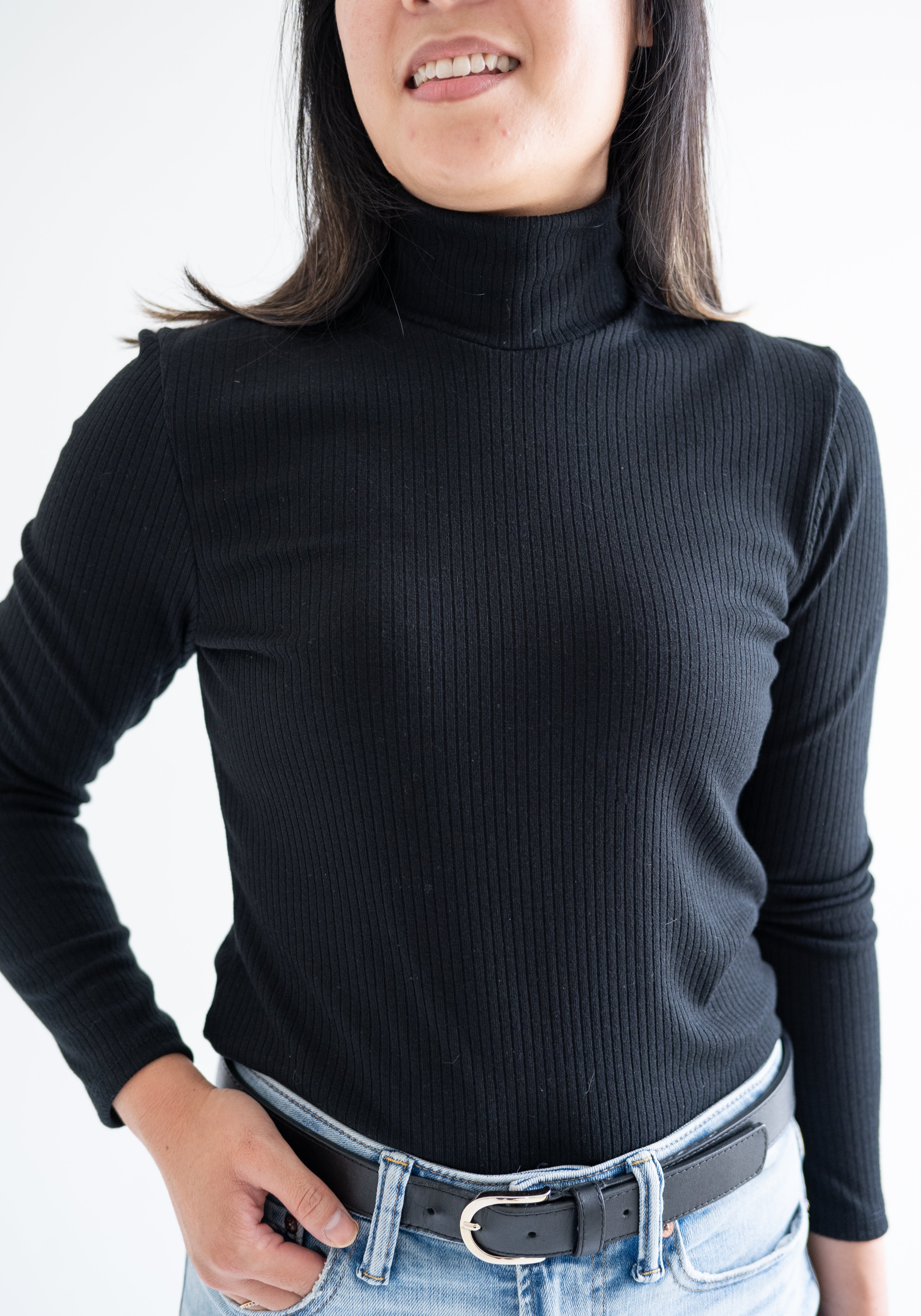 Close up of black turtleneck top for women