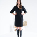 front view of black vneck long sleeved sweater knit dress for women