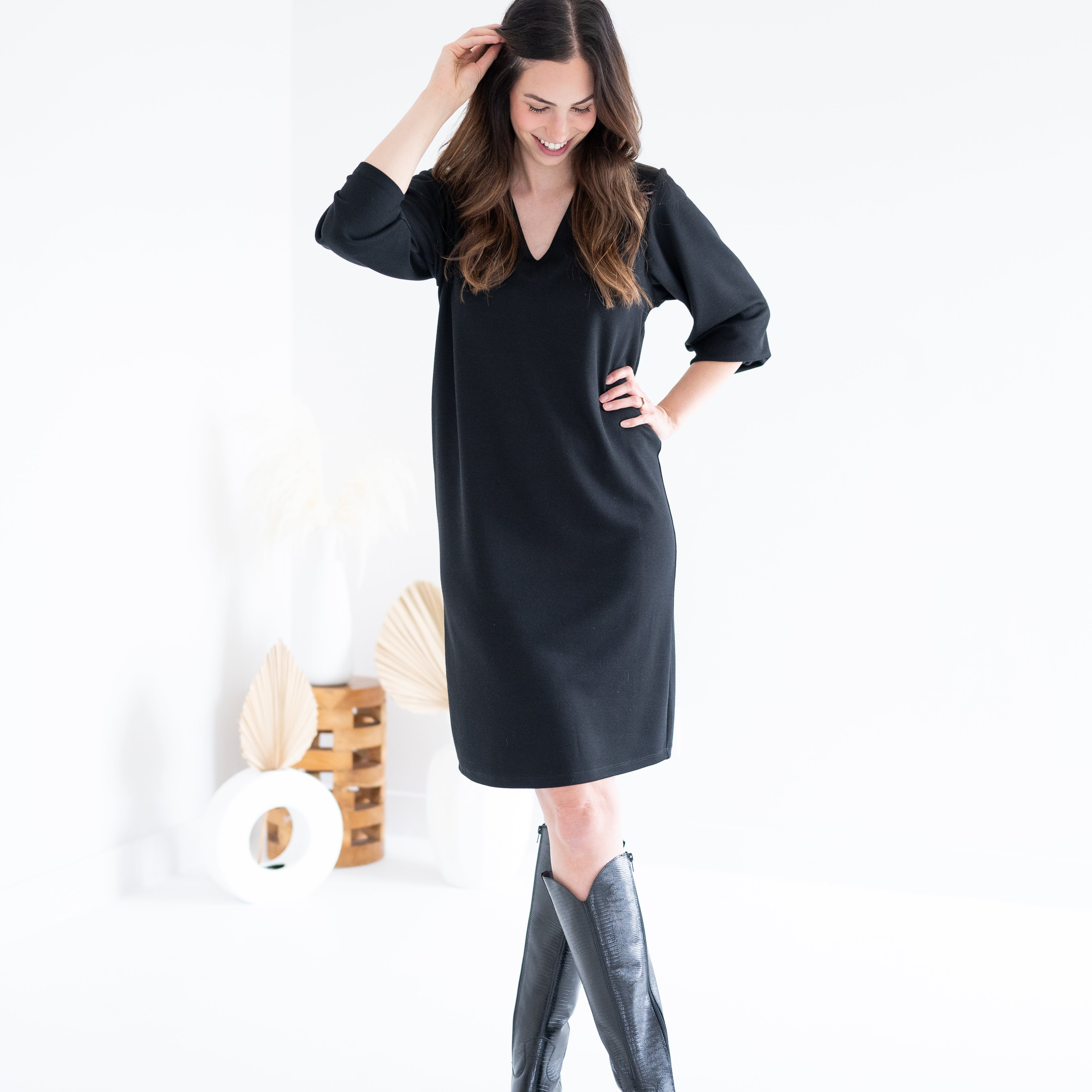 woman wearing black knee length sweater knit dress