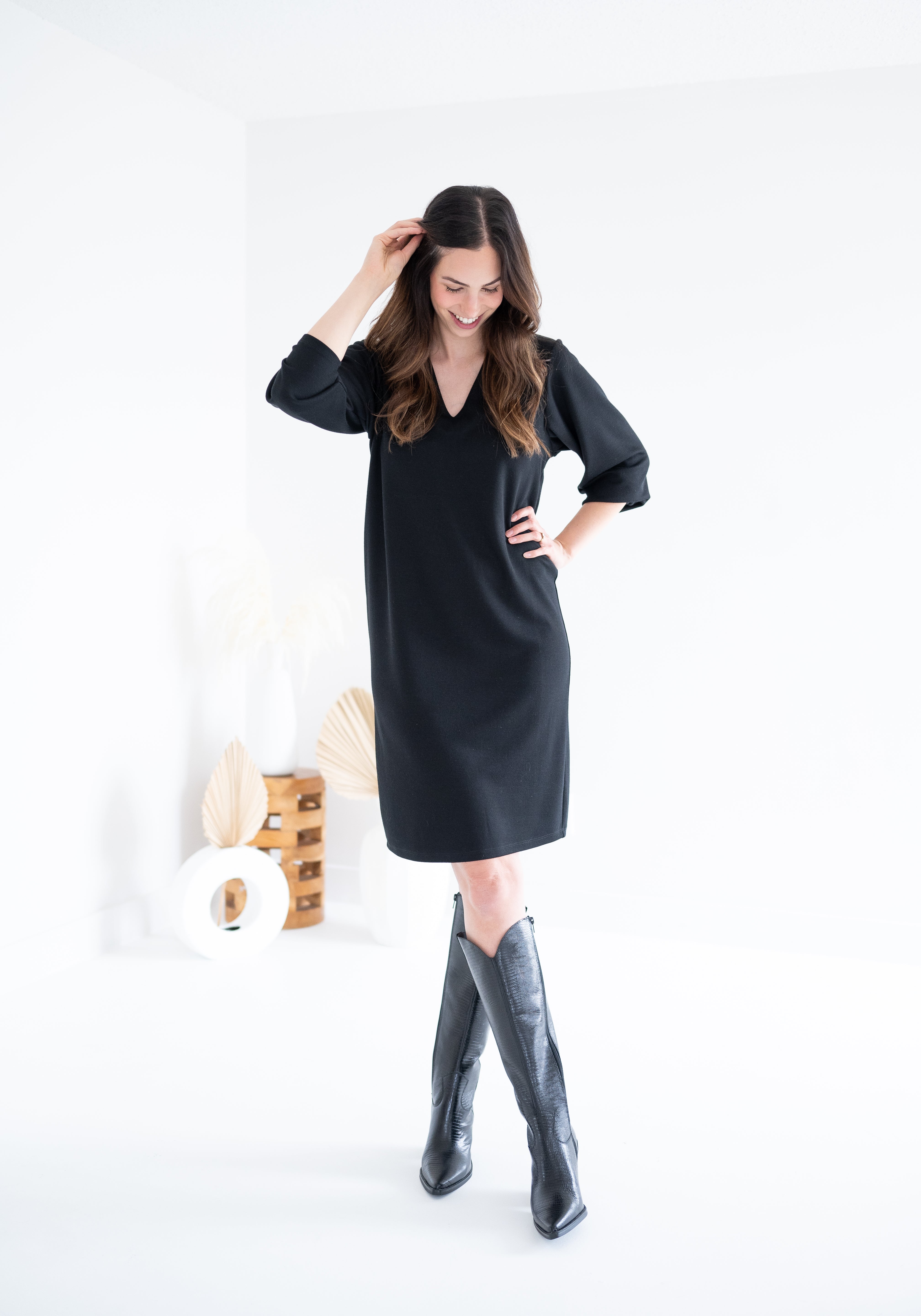 woman wearing black knee length sweater knit dress