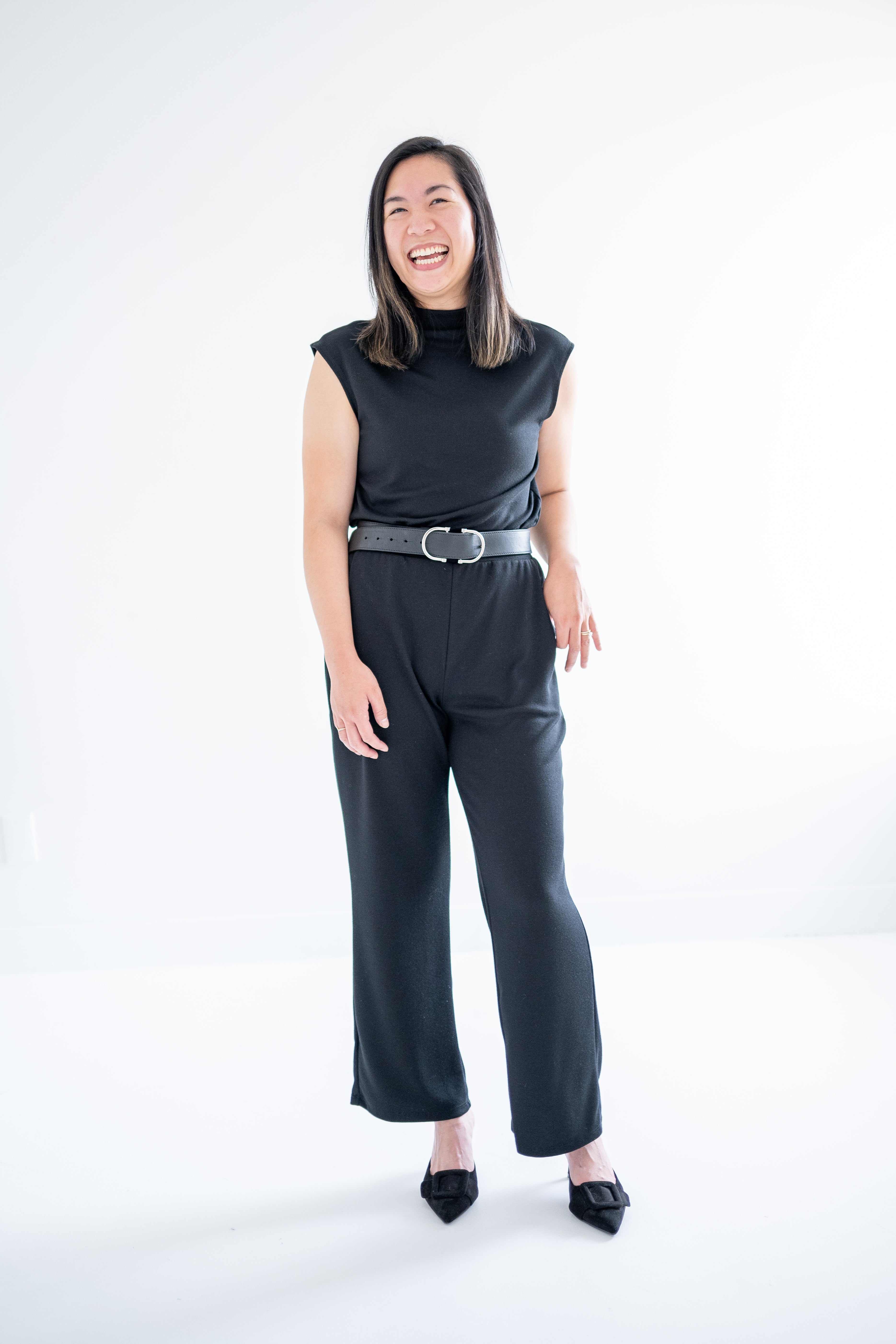 black mockneck sleeveless swaeter and wide leg pants for women