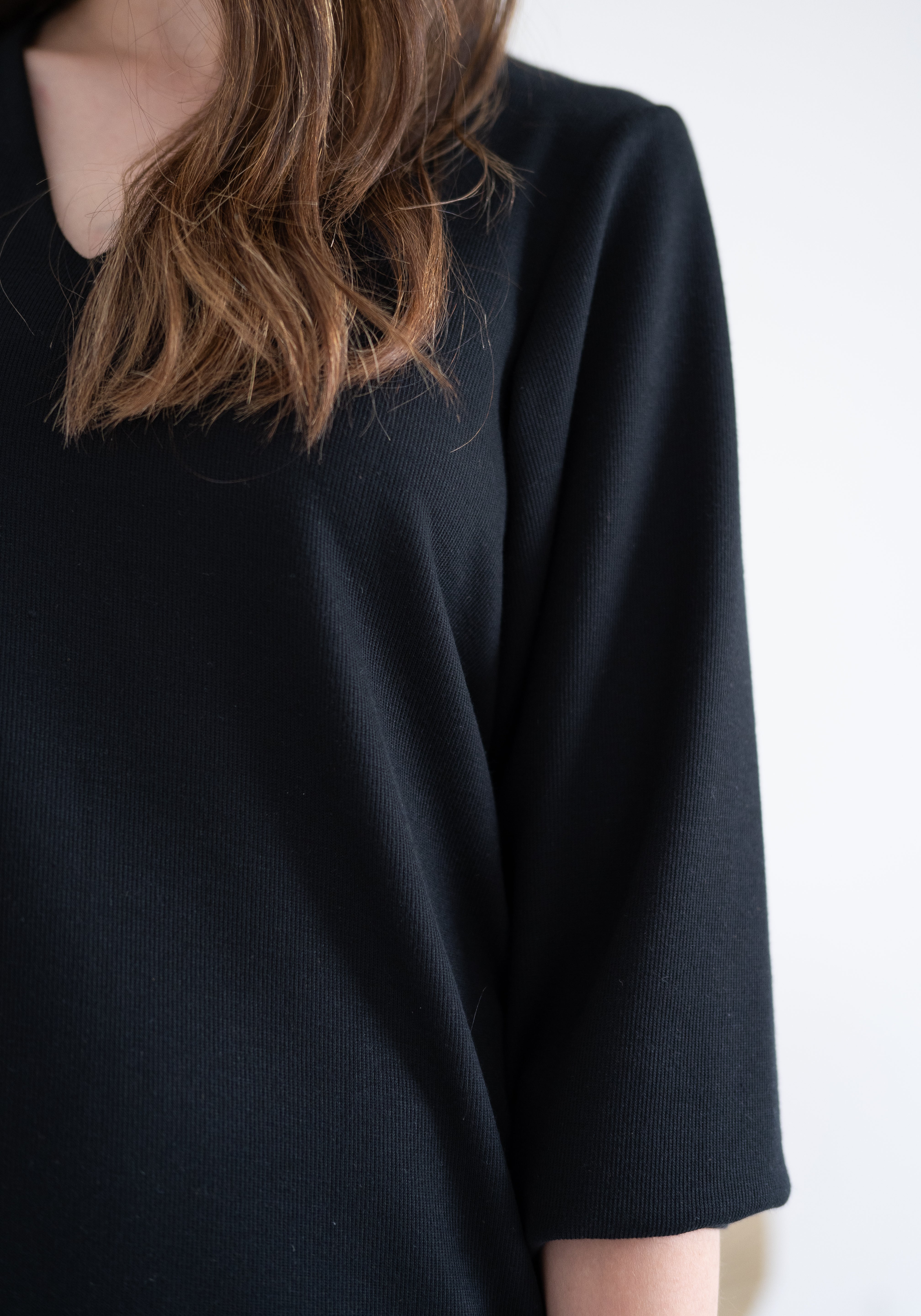 close up of black knee length sweater knit dress for women