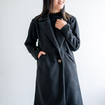 Black wool coat with one button. Wide collar knee length. Made in canada.