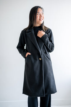 Black wool coat with one button. Wide collar knee length. Made in canada.