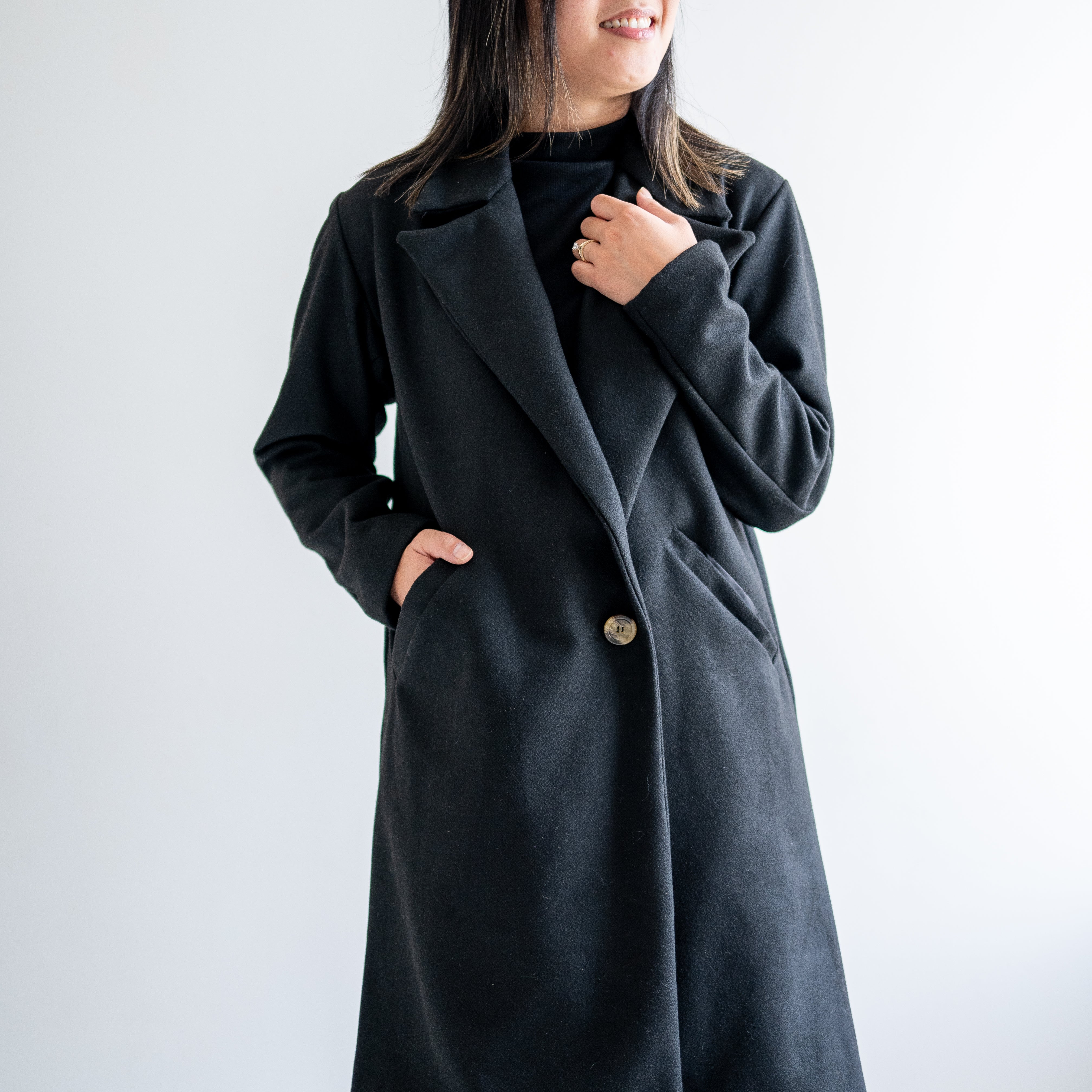 Black wool coat with one button. Wide collar knee length. Made in canada.