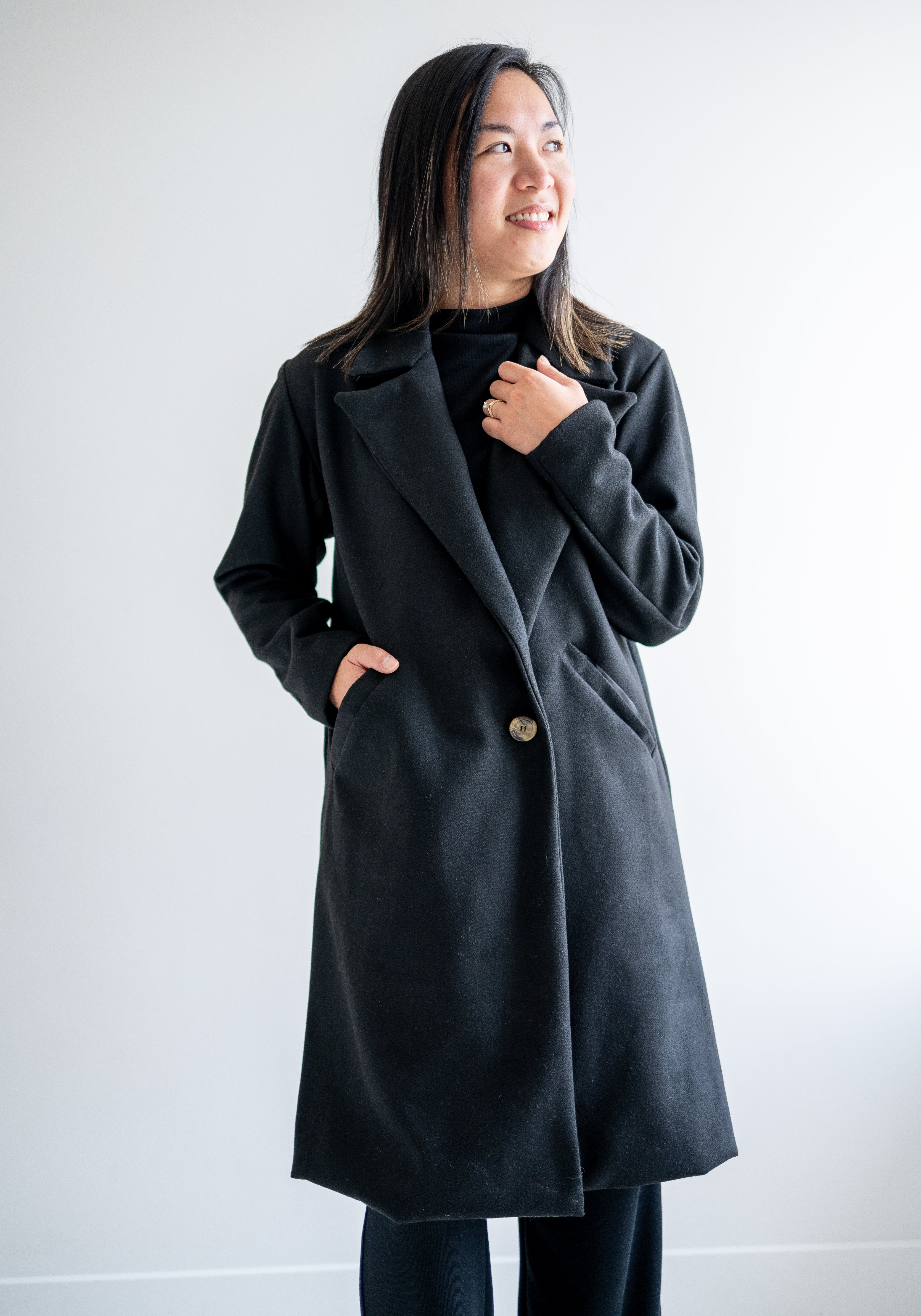 Black wool coat with one button. Wide collar knee length. Made in canada.