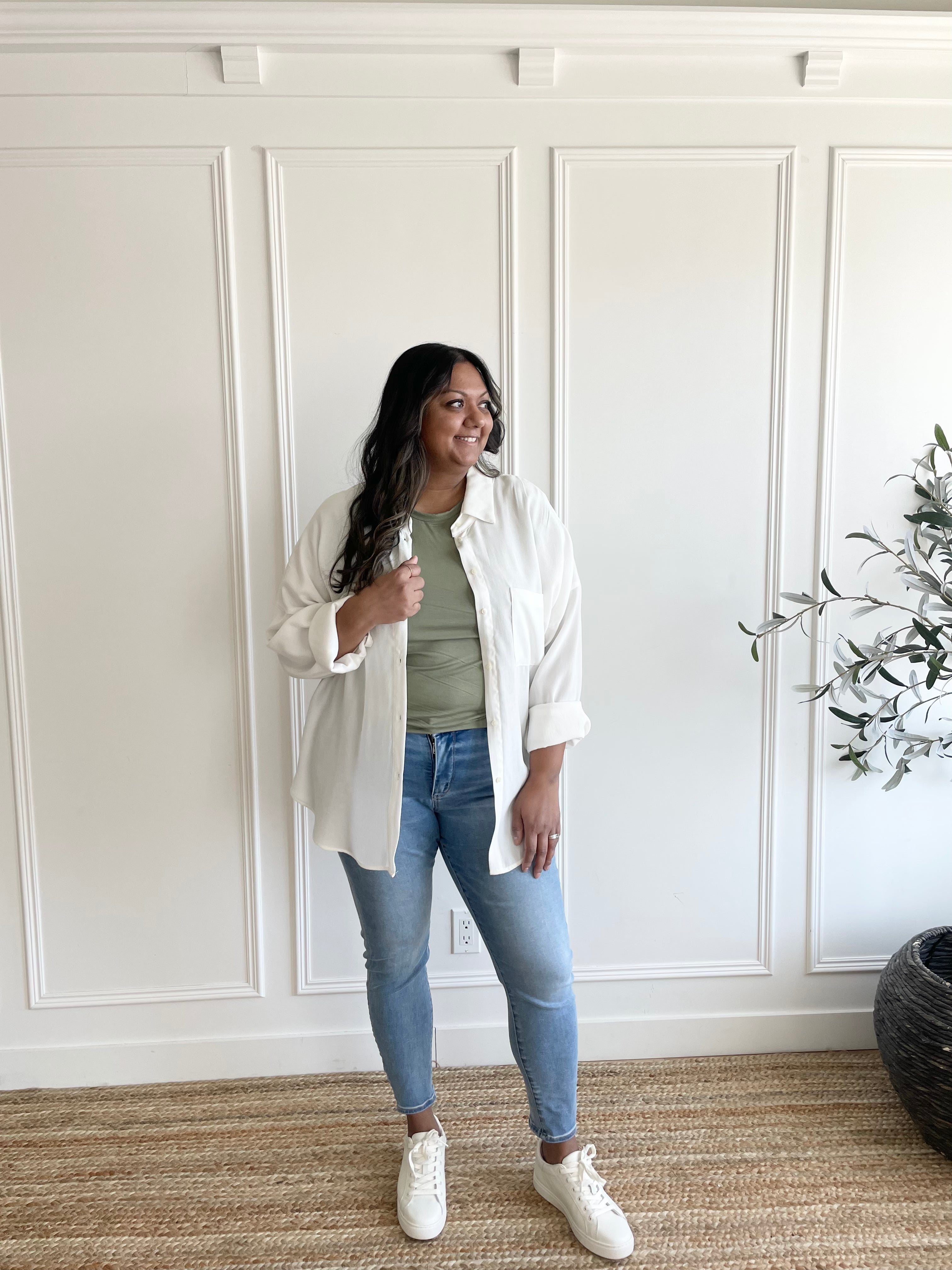 white button down shirt over sage green t-shirt