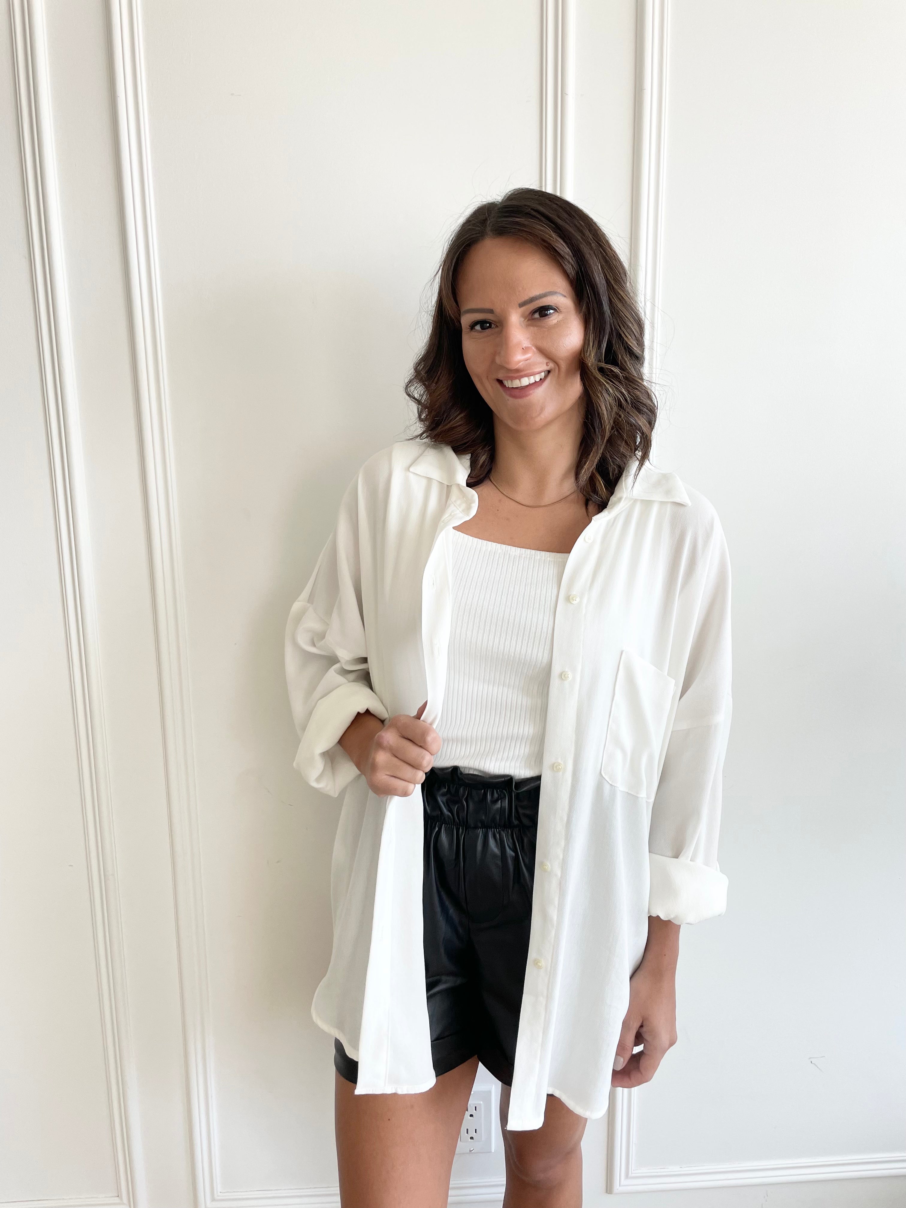 white oversized button-up shirt with vegan leather shorts