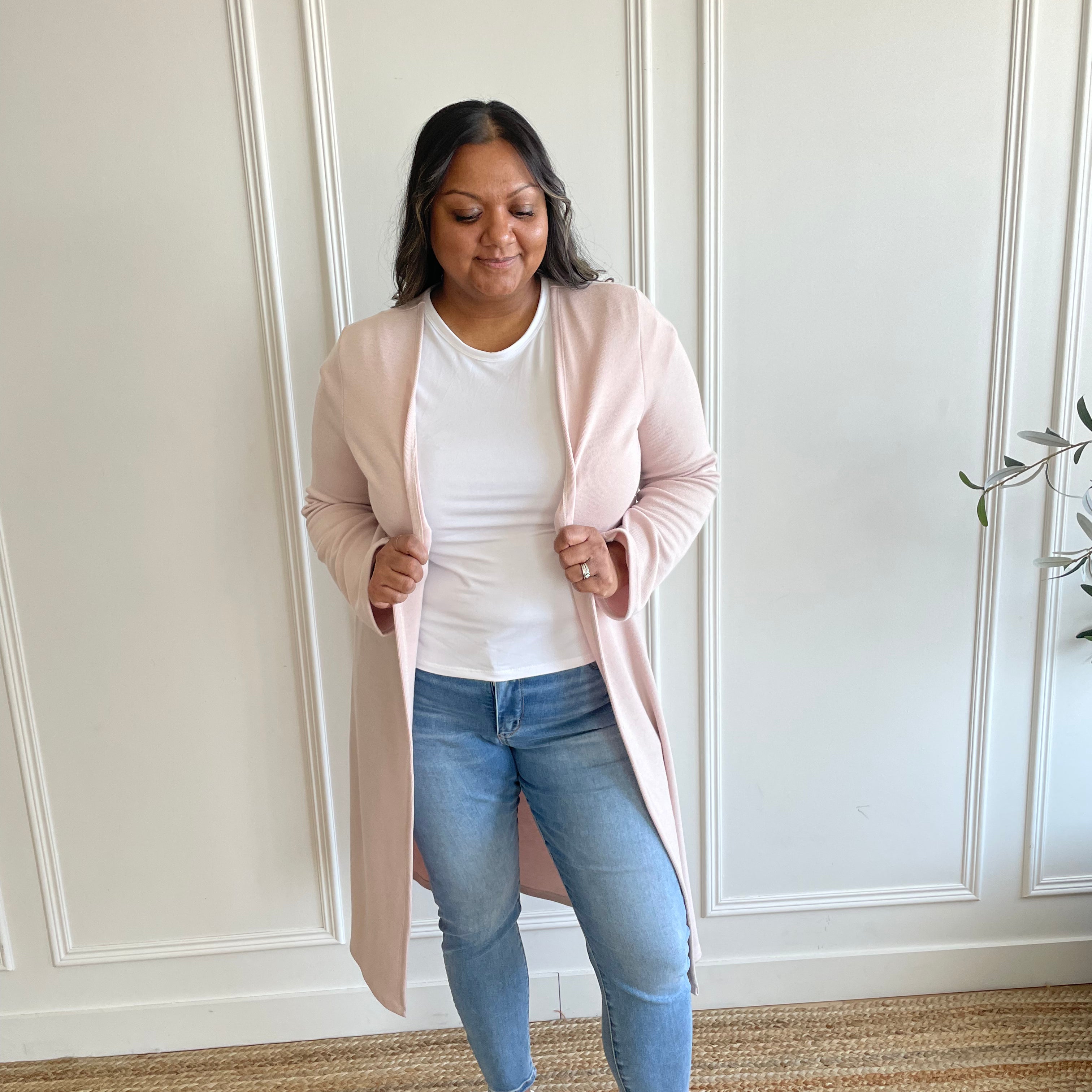 woman wearing light pink cardigan and white t-shirt