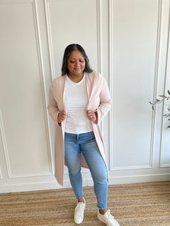 woman wearing light pink cardigan and white t-shirt