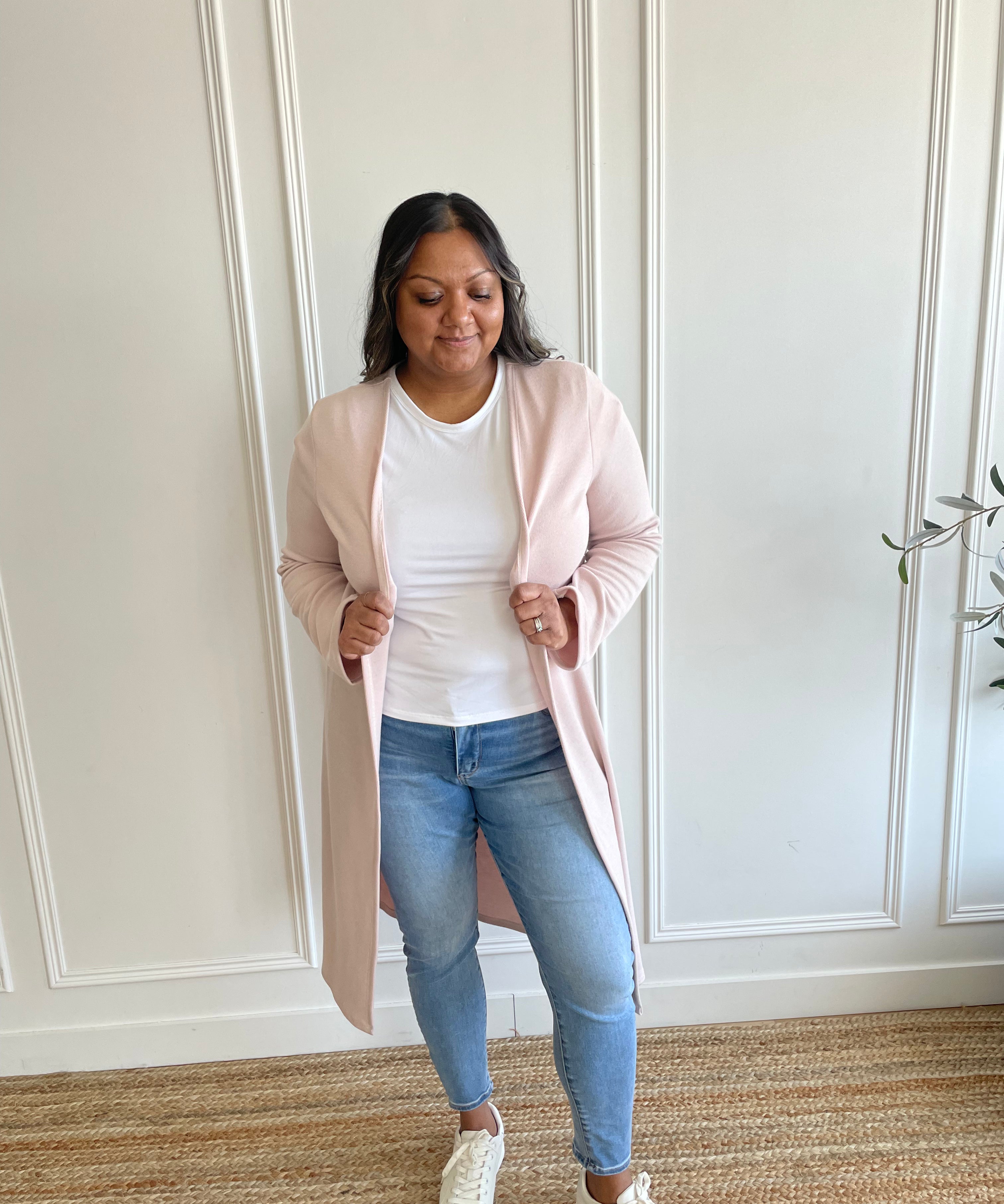 woman wearing light pink cardigan and white t-shirt