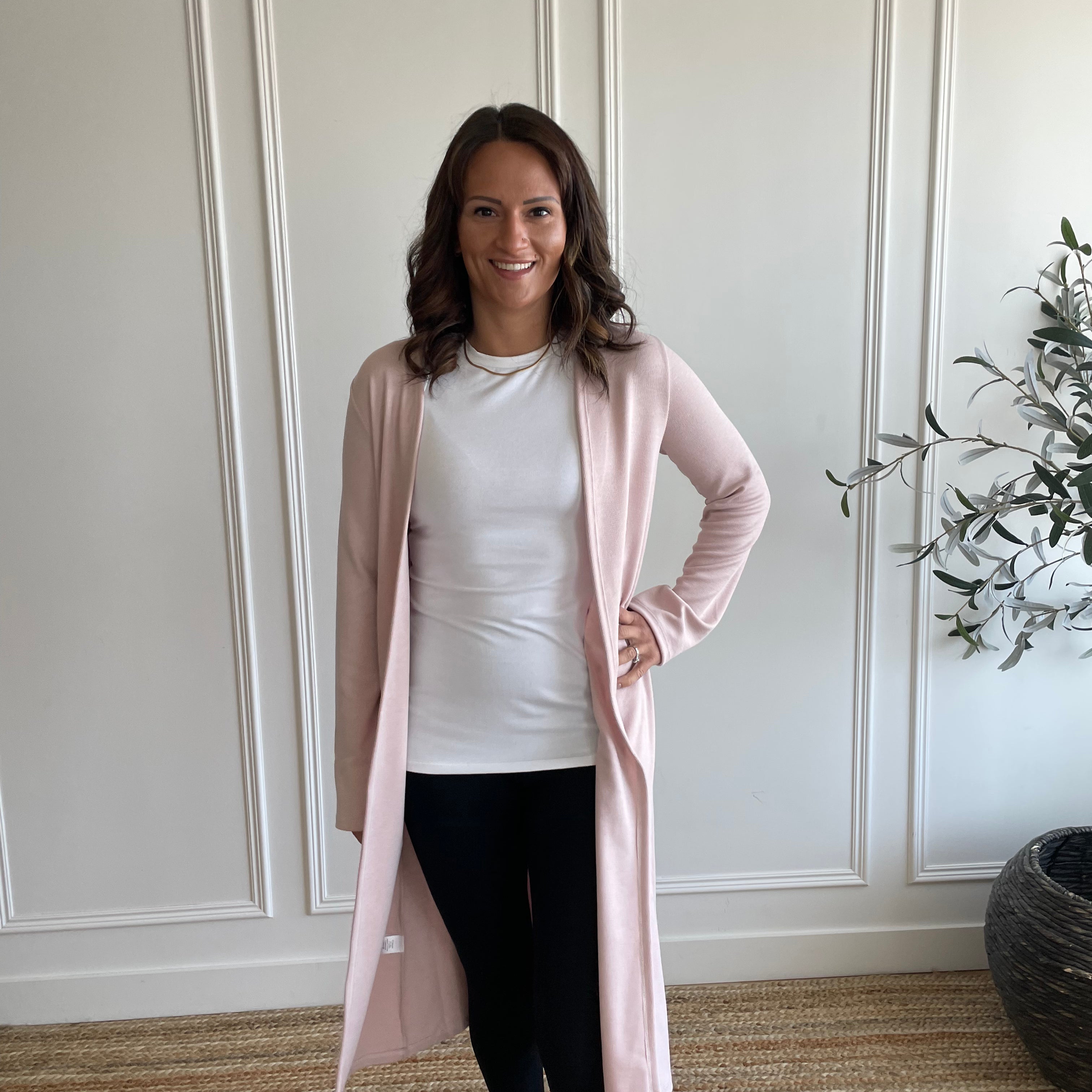 woman wearing light pink cardigan and white t-shirt