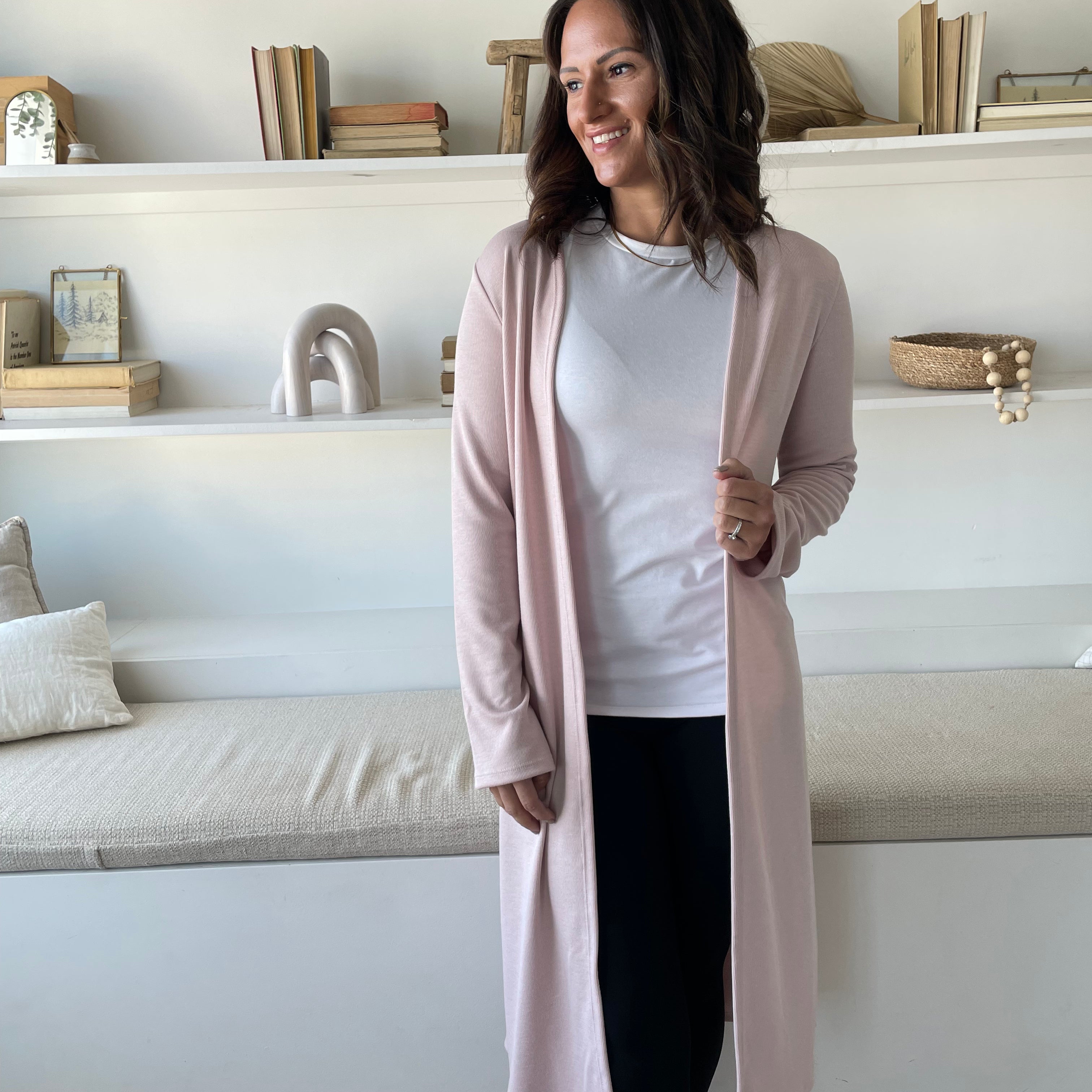 woman wearing light pink cardigan and white t-shirt