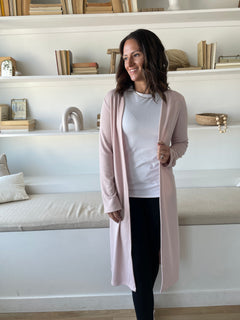 woman wearing light pink cardigan and white t-shirt