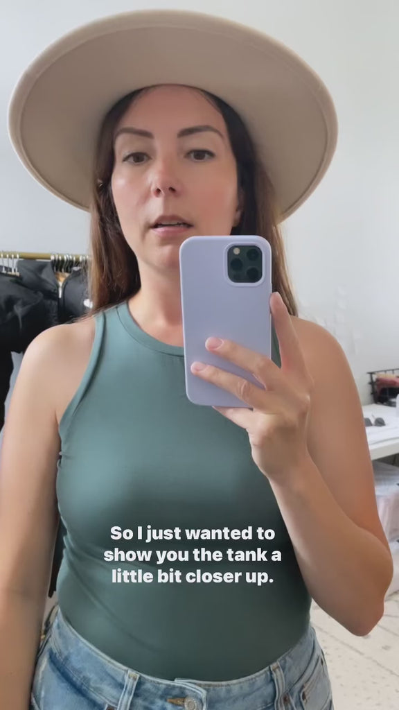 close up video of teal green tank top on model