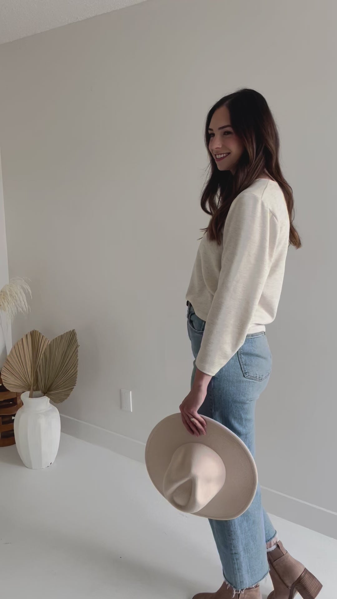 video of woman wearing cream sweater and jeans