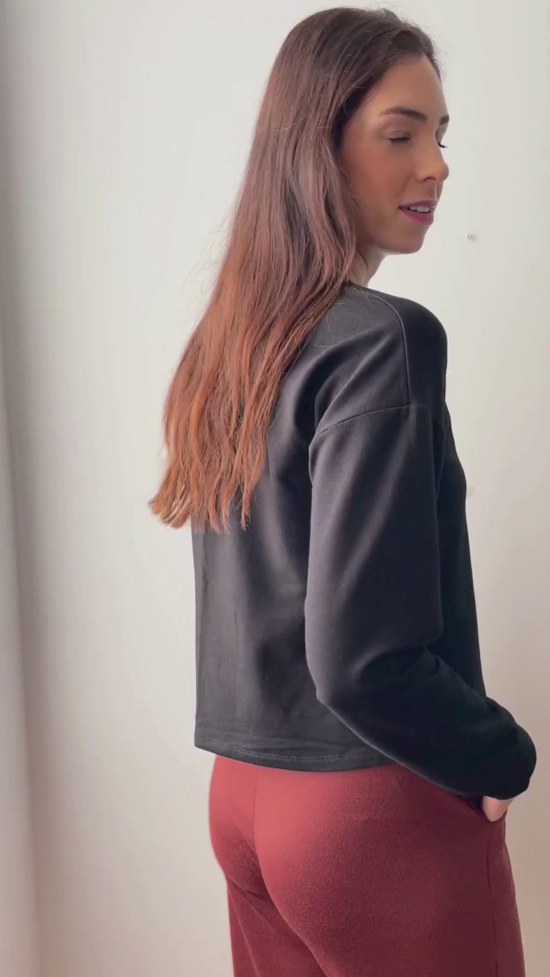 Video of model wearing black cropped crewneck